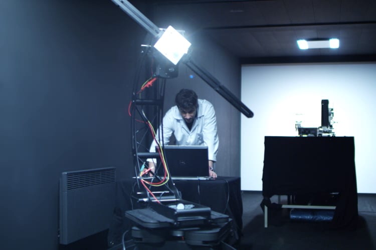 A technical worker doing photometric tests in a laboratory for lens manufacturer